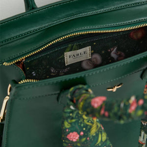 Interior View – A peek inside the bag, revealing the Into The Woods print lining and a zippered compartment.