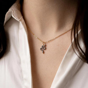 The necklace being worn, showcasing how it sits elegantly on the neckline, perfect for layering or standalone wear.