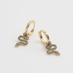 Side view of celestial snake huggie earrings, showing the textured star-studded hoops.