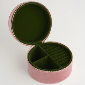 The interior of the jewellery box, lined in deep green fabric with organised compartments for rings and other treasures.