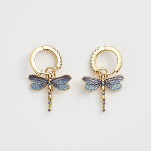 A pair of Fable England Dragonfly Crystal Earrings with blue enamel charms and gold-plated hoops on a white background.