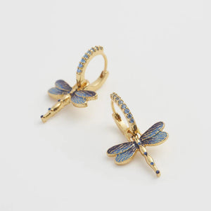 A close-up of the earrings, highlighting the sparkling cubic zirconia details and intricate dragonfly wings.