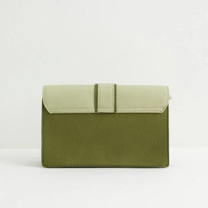 Image 7: The back of the bag in a solid green shade, with a structured design and a fold-over closure.