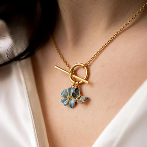 Model wearing the Forget Me Not Charm Toggle Necklace, showcasing its elegant fit and delicate detailing.