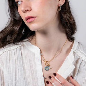 Woman wearing the Forget Me Not Charm Toggle Necklace with matching jewellery for a coordinated look.