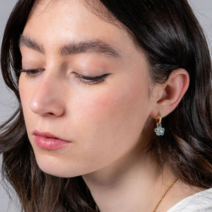 Model wearing the earrings – demonstrating how they sit on the ear with an elegant, feminine touch.