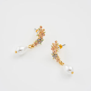 Side angle of the Hibiscus & Pearl Earrings, showing the intricate floral details and gold-plated metal.