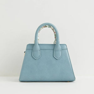 Back View: A clean and minimalistic back panel of the blue tote bag, highlighting its compact and structured design.