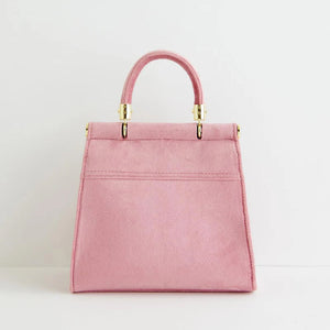 Back view of the Mini Pink Tote, showcasing the smooth, soft pink velvet without embroidery for a minimalist finish.