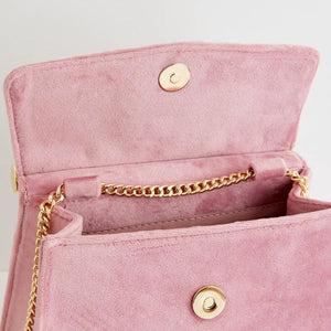 Open view of the tote showing the magnetic popper fastening and gold chain strap inside, demonstrating secure and stylish storage.