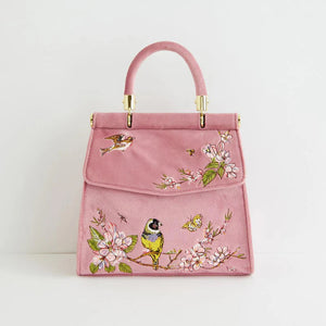 Front view of the Fable England Morning Song Bird Embroidered Mini Pink Tote, showcasing intricate bird and floral embroidery on a soft pink velvet background.