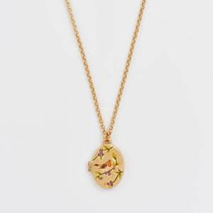 Close-up of Robin & Blackberry Gold Oval Locket Necklace on gold chain with enamel bird and berry design.