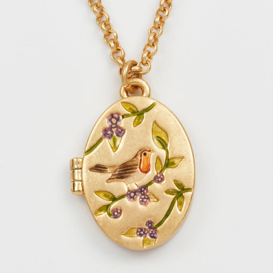 Detailed view of Robin & Blackberry Gold Locket showing enamel robin and blackberry design on gold oval pendant.