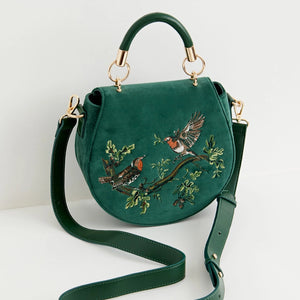 Robin Love green velvet embroidered crossbody saddle bag with adjustable strap and top handle.