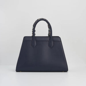 The back of the navy tote bag, featuring a minimalist design with clean stitching and a structured shape for a refined look.