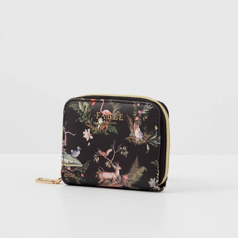 Side angle of Wonderland Black Small Wallet showing gold zip and illustrated pattern.