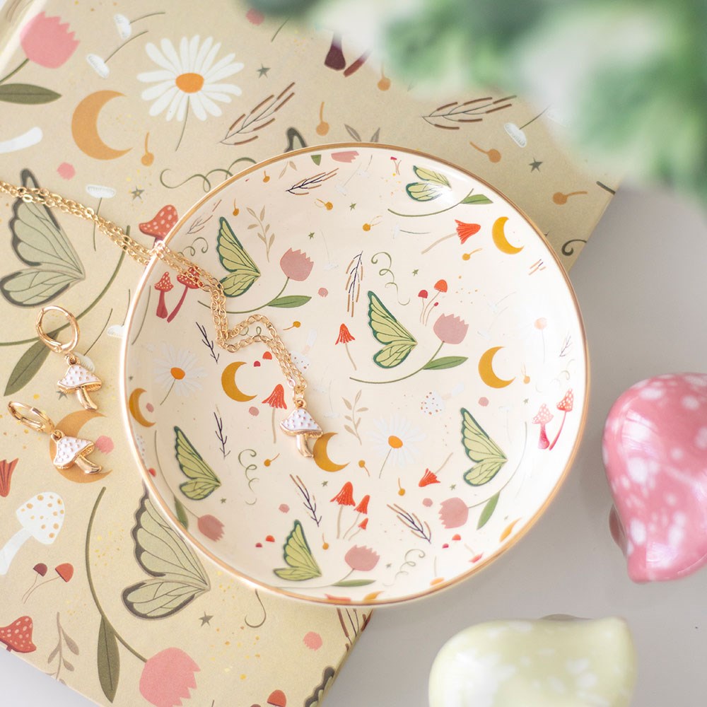 Fairy Folklore Print Trinket Dish styled with jewellery on a floral background.
