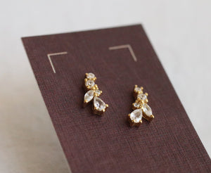 Gold vermeil cubic zirconia leaf-shaped stud earrings displayed on a jewellery card.