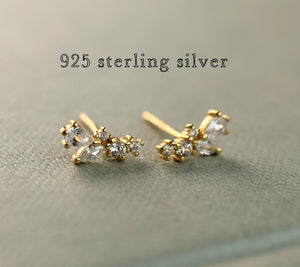 Hand holding Fairy Wing Tiny Petal Leaf Stud Earrings, highlighting their delicate size.