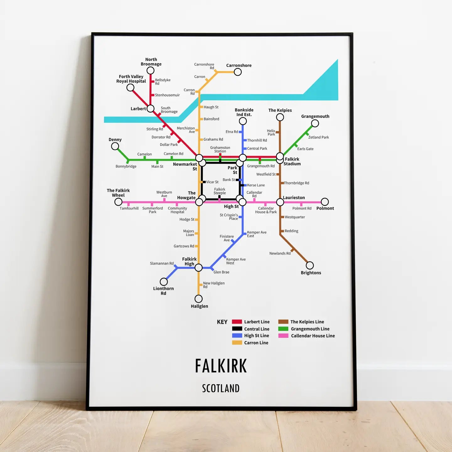 Falkirk underground-style transport map print displayed in a black frame on wooden floor.