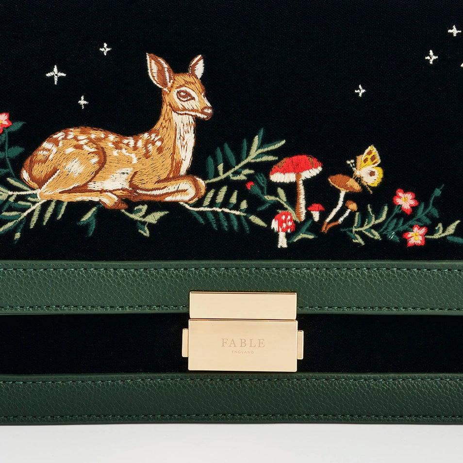 Detailed embroidery of fawn, toadstools, and stars on the front flap of the Fawn Green Crossbody Bag.