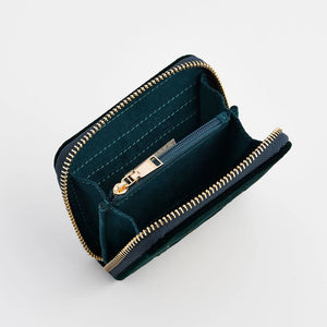 Interior view of small green purse with card slots and coin pocket.