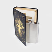 Flask hidden inside a black and gold faux book titled “The Good Book” with a stainless steel cap visible from the open cover.