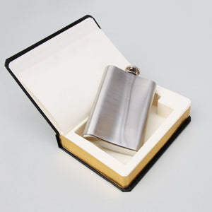 Open novelty book showing hollowed-out pages with a removable 4oz stainless steel hip flask nestled inside.