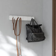 Umbra Flip 5 wall hook in white with bag and scarf hanging on grey wall