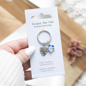 Forget-Me-Not Flower Keyring with blue enamel charm and heart pendant on a decorative card.