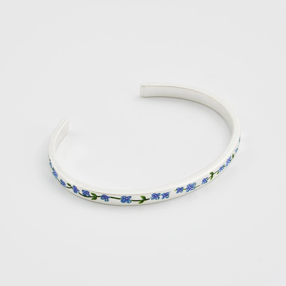 Forget-Me-Not bangle displayed in elegant gift box with velvet insert.