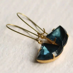 A pair of French Navy Art Deco earrings featuring vintage glass jewels in a rich navy blue shade, set in gold-plated settings, resting on a neutral background.