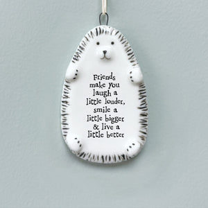 East of India porcelain hedgehog hanger with a heartfelt friendship quote - ‘Friends make you laugh a little louder, smile a little bigger & live a little better.’ A thoughtful gift for friends and special occasions.