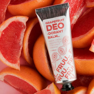 FRUU Grapefruit & Juniper Berry Deodorant Balm 60ml surrounded by fresh grapefruit slices – bold citrus-scented natural deodorant balm.