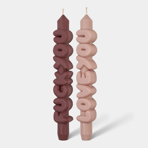 Front view of mocha and cream taper candles spelling ’Fck You’ and ‘Love You’ in bold 3D lettering, standing upright on a white background.*
