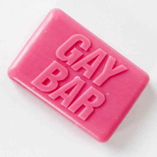 Hot-pink novelty soap bar embossed “GAY BAR” on white background – rose-scented LGBTQ+ gift from Contempo.