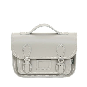Leather satchel in a light grey leather. The satchel has a top handle and two buckle closers.