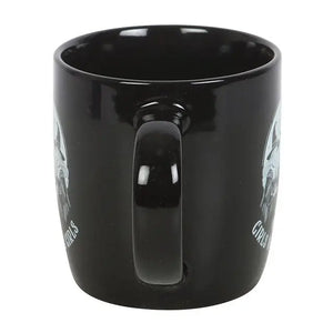 Back handle view of black witchy mug showing side designs of spell-casting witches.