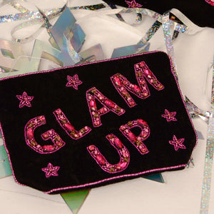 Black velvet Glam Up Pouch styled with party decorations.
