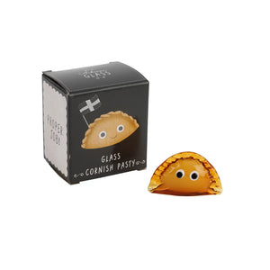 Glass Cornish pasty ornament with googly eyes displayed next to branded black gift box featuring cute pasty illustration and Cornish flag.