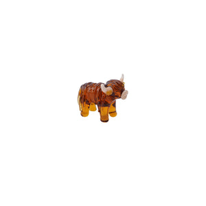 Side view of Glass Highland Cow Ornament – A side profile of the glass Highland cow figurine, showcasing its lifelike details and rich amber colour.