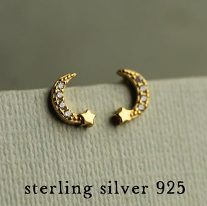 Detailed shot of gold vermeil moon earrings with sparkling crystals and “sterling silver 925” label.