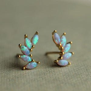 A pair of gold vermeil opal wing stud earrings featuring marquise-cut opals set in gold-plated sterling silver, displayed on a soft fabric background.