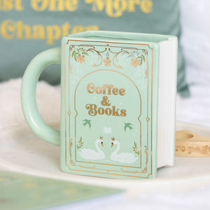 Green ceramic book-shaped mug with “Coffee & Books” design and swan illustration on front.