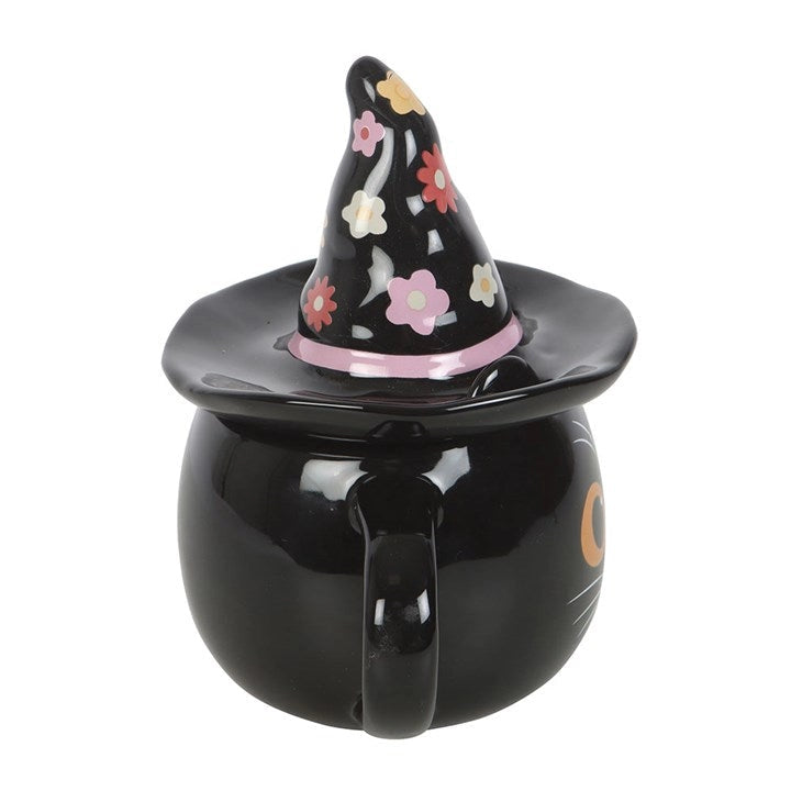 Rear view of black ceramic mug with pink-banded floral witch hat lid and handle.