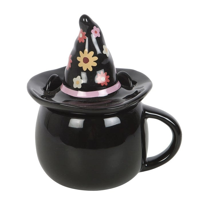 Angled side view of Groovy Witch Hat Mug showing glossy ceramic finish, floral lid, and curled handle.