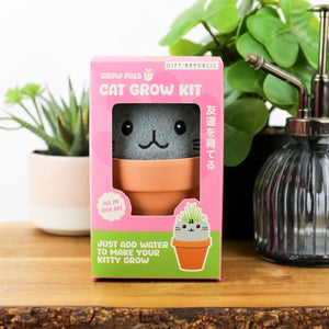 Grow Pals cat grow kit packaged in pink and green box on wooden surface.