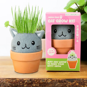 Cute cat-shaped grow kit in terracotta pot with green grass growing from head.