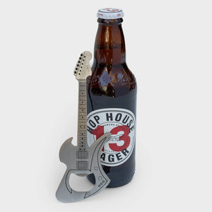 Heavy-duty guitar bar blade resting against Hop House Lager.