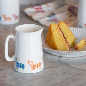 Highland Cow Jug on a kitchen counter with cake and matching accessories.